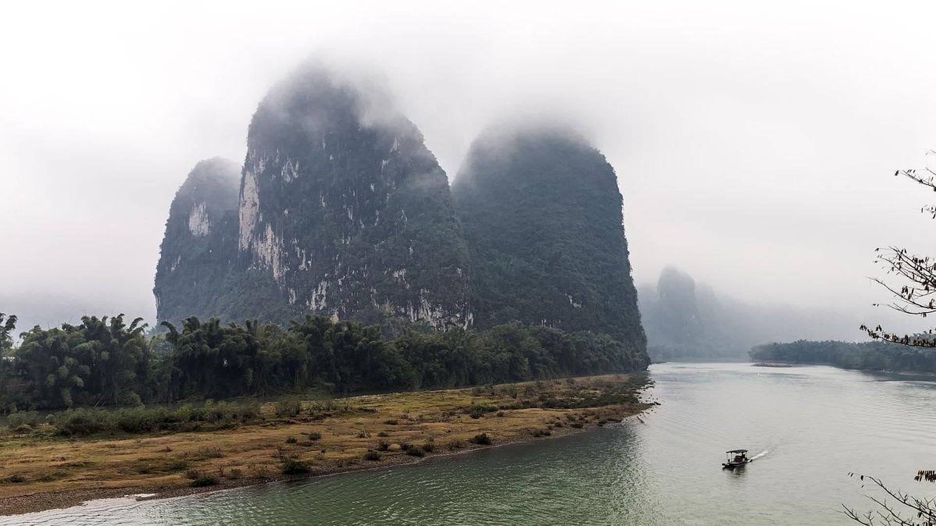 bamboo raft Li River valley misty limestone peaks