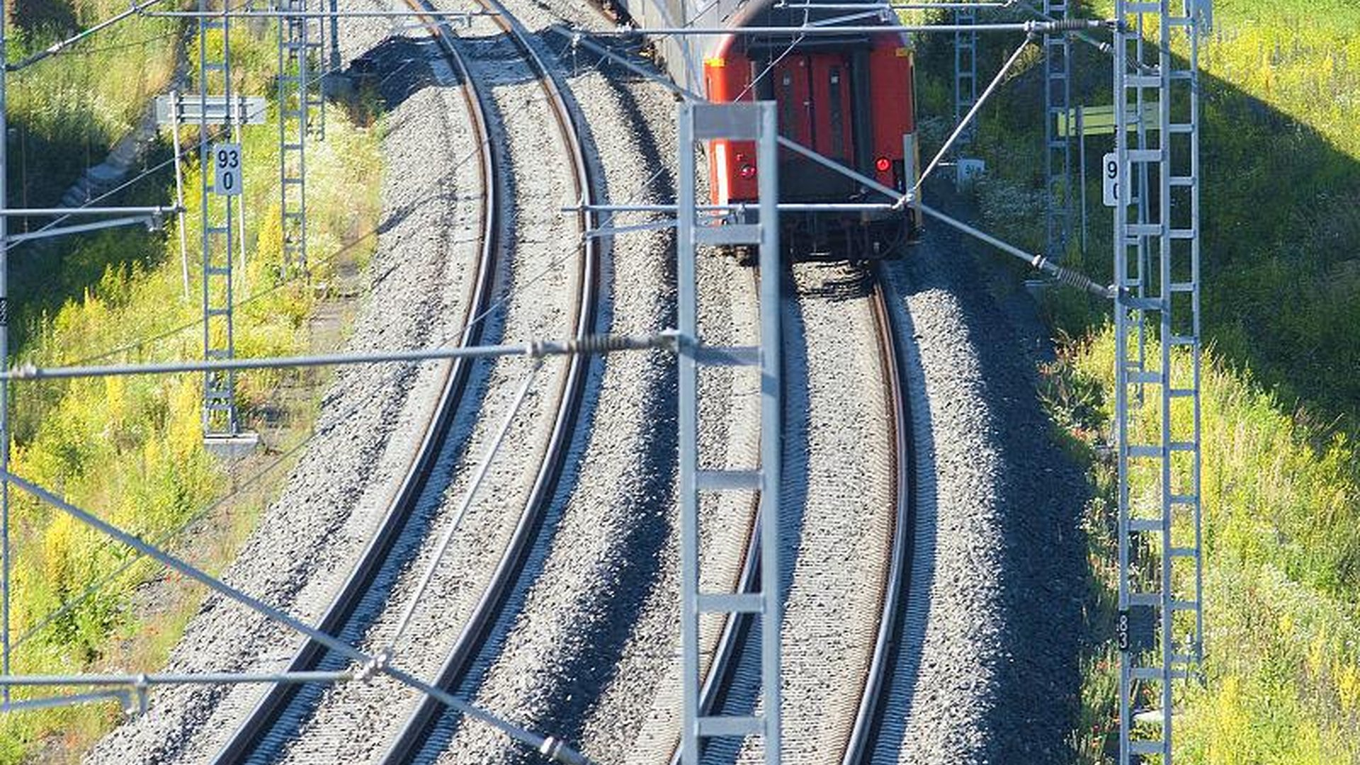 high-speed train traveling through Chinese countryside with modern tracks and scenic views