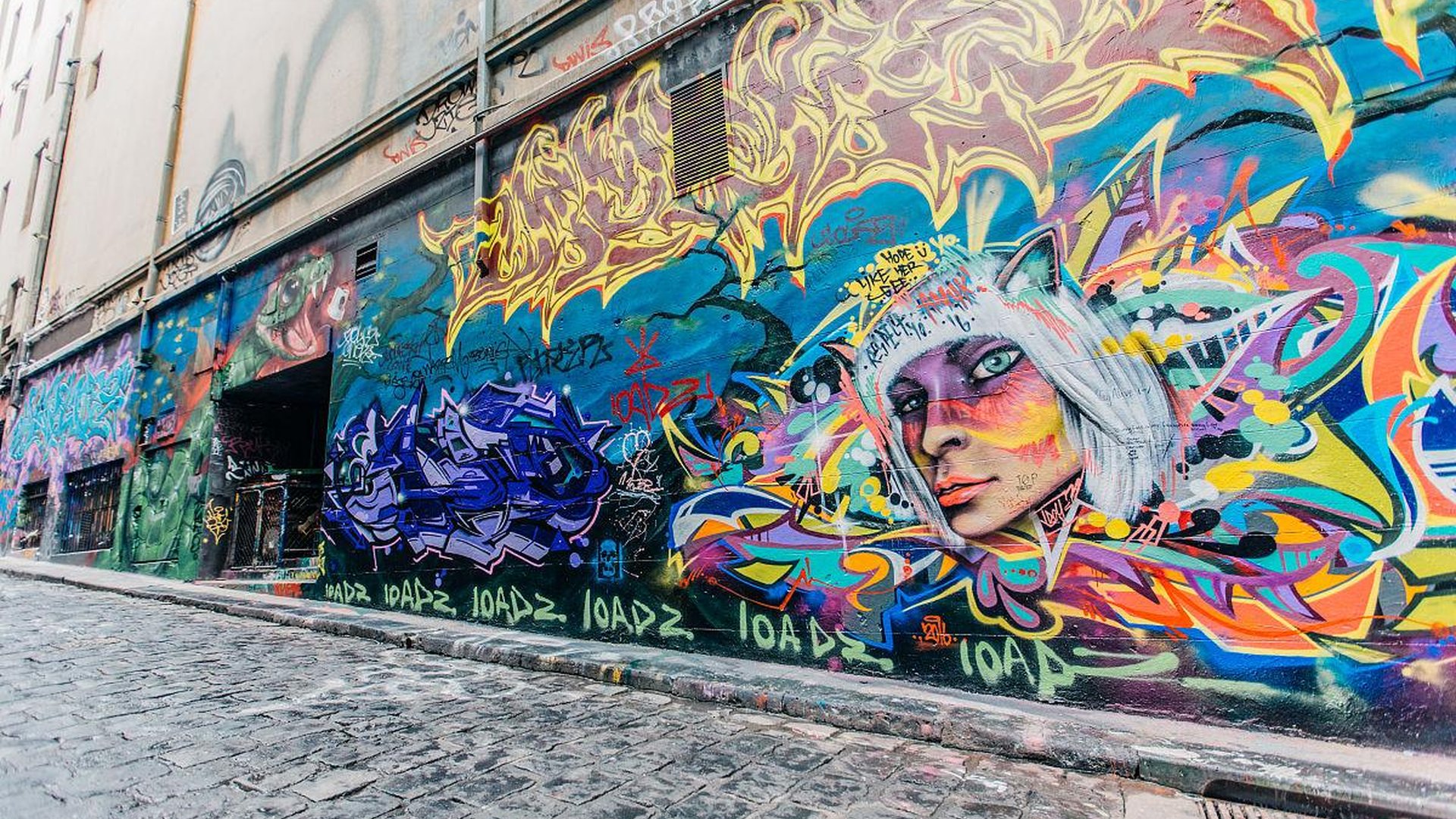 urban street art in alleyway, colorful graffiti on brick wall, city life background, artist painting on wall