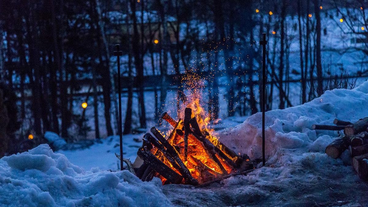 Solo traveler Iceland wilderness wooden cabin fire