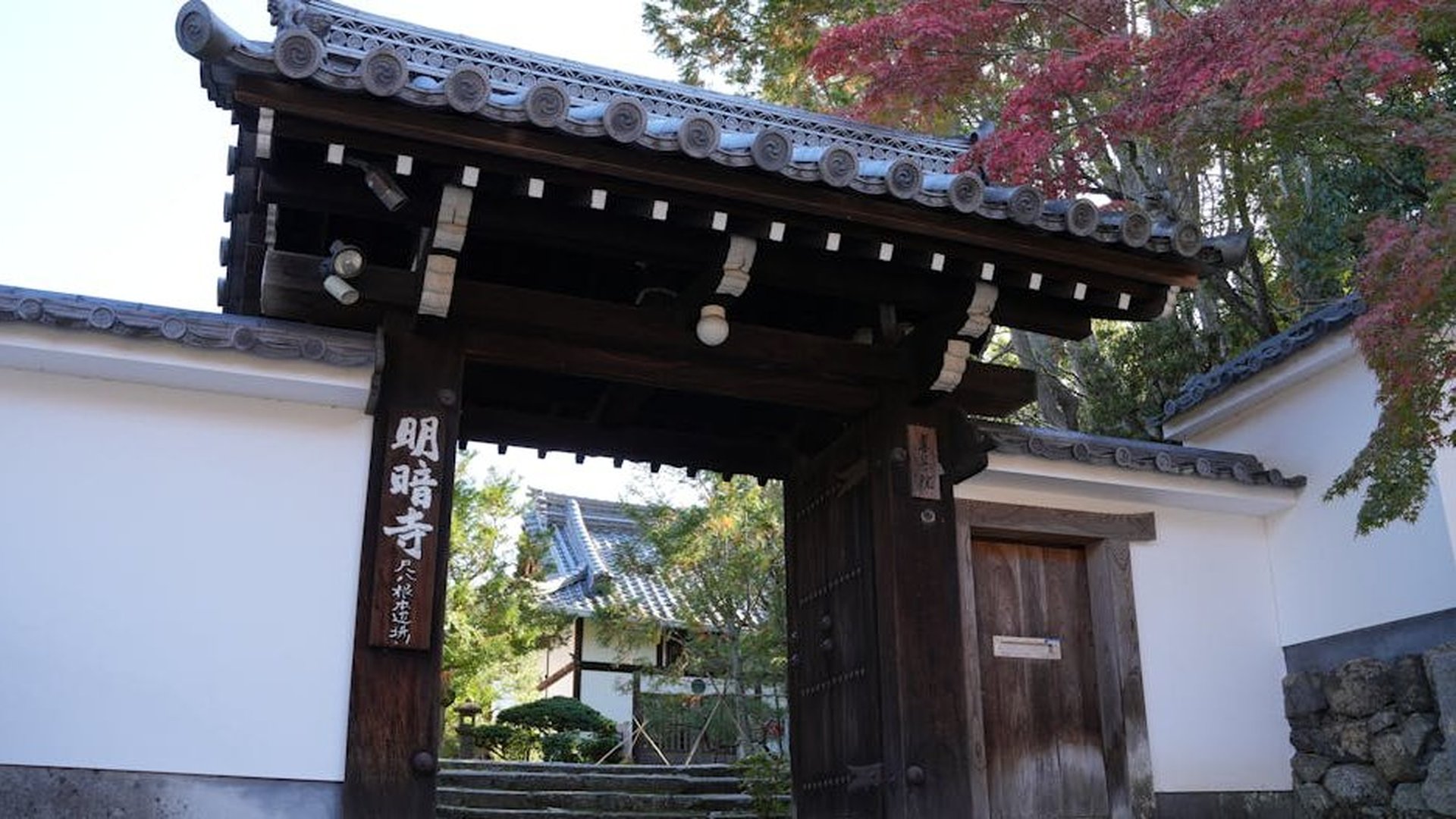 a peaceful sunrise over a quiet bamboo forest in Kyoto, Japan, with a single wooden temple gate visible in the mist, soft golden light, serene and spiritual mood